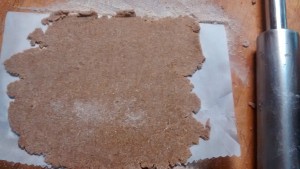 Whole wheat pie crust rolled out on parchment paper