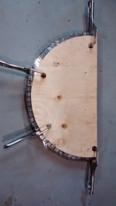 Stainless steel sheet clamped to the form in preparation for bending the tabs