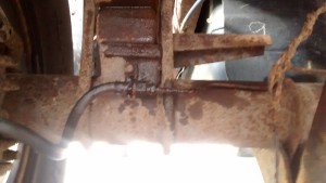 Brake line in the process of being removed.  The break in the line was a consequence of working to remove the line.