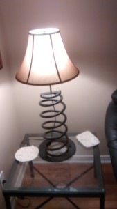 Table lamp made from a coil spring and a disk brake